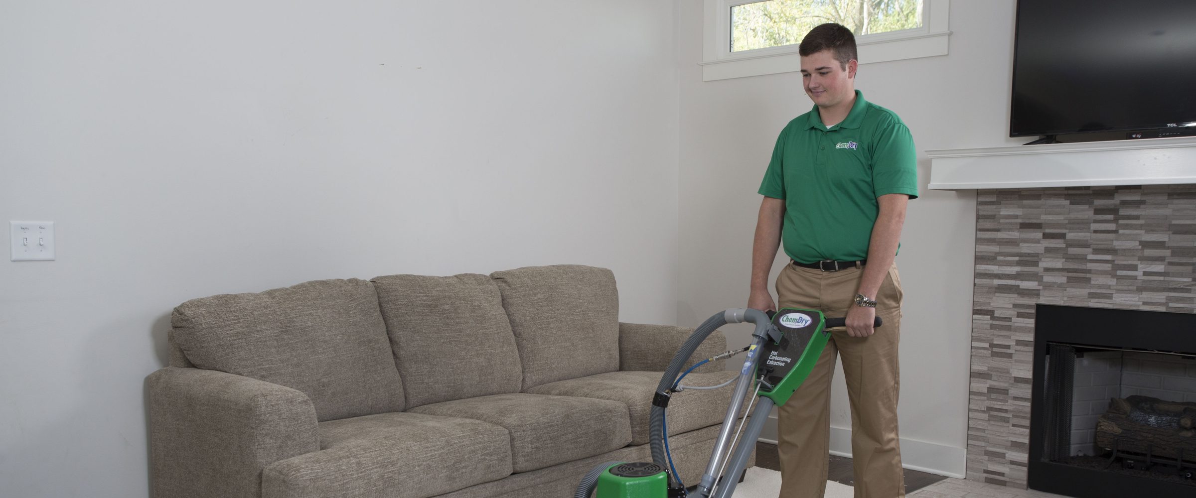 Chem-Dry technician cleaning carpet in a living room